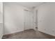 Bright bedroom features carpet, white walls, closet, and access to another room at 9222 W Roma Ave, Phoenix, AZ 85037