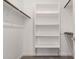 Walk-in closet with shelves, clothing racks, and neutral carpet; providing ample storage at 9222 W Roma Ave, Phoenix, AZ 85037