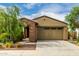 Inviting single-story home with a low-maintenance front yard and a two-car garage at 9222 W Roma Ave, Phoenix, AZ 85037