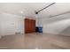 Spacious two car garage features epoxy floor and storage cabinets at 9222 W Roma Ave, Phoenix, AZ 85037