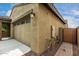 Side view of the home showing the garage, with a convenient side access door at 9222 W Roma Ave, Phoenix, AZ 85037
