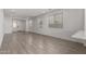 Spacious living room featuring neutral walls and stylish tiled floors at 9222 W Roma Ave, Phoenix, AZ 85037