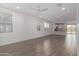 Expansive living space featuring modern floors, recessed lighting, and an open-concept design at 9222 W Roma Ave, Phoenix, AZ 85037