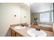 Well-lit bathroom featuring dual sinks, tile countertops, and a large mirror at 9431 E Coralbell Ave # 6, Mesa, AZ 85208