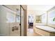 Bright bathroom with glass-door shower, soaking tub, and view into the spacious main bedroom at 9431 E Coralbell Ave # 6, Mesa, AZ 85208