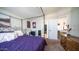 Spacious bedroom featuring a distinctive canopy bed, soft lighting, and an open closet area at 9431 E Coralbell Ave # 6, Mesa, AZ 85208
