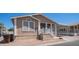 Inviting tan home with covered carport, front porch, and desert landscaping at 9431 E Coralbell Ave # 6, Mesa, AZ 85208