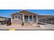 Tan home with a covered porch and carport provides covered parking at 9431 E Coralbell Ave # 6, Mesa, AZ 85208