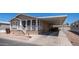 Charming home with covered parking, front porch, and well-maintained landscaping at 9431 E Coralbell Ave # 6, Mesa, AZ 85208