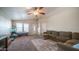 Spacious living room featuring a ceiling fan, large windows, and plush seating at 9431 E Coralbell Ave # 6, Mesa, AZ 85208