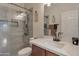 Bright bathroom featuring a frameless glass shower and a granite vanity at 9948 W Chipman Rd, Tolleson, AZ 85353