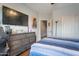 Comfortable bedroom with dark wood furniture and laminate wood flooring at 9948 W Chipman Rd, Tolleson, AZ 85353