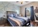 Spacious bedroom featuring geometric accent wall and wood laminate flooring at 9948 W Chipman Rd, Tolleson, AZ 85353