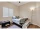 Cozy bedroom features a window for natural light and hardwood floors at 9948 W Chipman Rd, Tolleson, AZ 85353