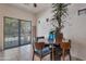 Casual dining area with wood table, chairs, ceiling fan, and sliding glass door to the outside at 9948 W Chipman Rd, Tolleson, AZ 85353