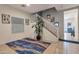 Welcoming entryway featuring neutral tile flooring, stairs to the upper level, and decorative area rug at 9948 W Chipman Rd, Tolleson, AZ 85353