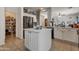 Kitchen area featuring an island, stainless steel appliances, and a walk-in pantry with shelving at 9948 W Chipman Rd, Tolleson, AZ 85353