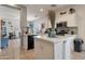 Bright kitchen featuring white cabinets, stainless appliances, tile backsplash, and center island with countertop at 9948 W Chipman Rd, Tolleson, AZ 85353