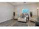 Inviting living room showcasing seating, neutral tones, wood-look flooring, and natural light at 9948 W Chipman Rd, Tolleson, AZ 85353