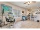 Bright and spacious living area showcasing tile floors, recessed lighting, and an open layout to the kitchen at 9948 W Chipman Rd, Tolleson, AZ 85353