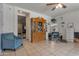 Spacious living room with tiled floors, a decorative cabinet, and an open doorway leading to another room at 9948 W Chipman Rd, Tolleson, AZ 85353