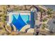 Aerial view of a community pool and clubhouse with lap lanes, lounge chairs, and large sunshade structures at 1008 W Heatherwood St, San Tan Valley, AZ 85140