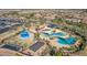 Aerial view of a community pool area with shaded pools, landscaping, and other common neighborhood areas at 1008 W Heatherwood St, San Tan Valley, AZ 85140
