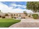 Backyard with water fountain feature, artificial grass and desert landscaping on gravel at 1008 W Heatherwood St, San Tan Valley, AZ 85140