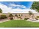 Beautiful backyard with artificial grass, desert landscaping, and a water feature at 1008 W Heatherwood St, San Tan Valley, AZ 85140