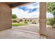 Backyard patio leads to artificial grass, desert landscaping, and a water fountain at 1008 W Heatherwood St, San Tan Valley, AZ 85140