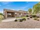 Beautiful backyard showing desert landscaping with a fountain, small grass area and patio at 1008 W Heatherwood St, San Tan Valley, AZ 85140