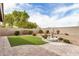 Backyard with a water fountain, artificial grass and desert landscaping at 1008 W Heatherwood St, San Tan Valley, AZ 85140