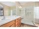 Bright bathroom featuring a glass enclosed shower, double sink, and natural light at 1008 W Heatherwood St, San Tan Valley, AZ 85140
