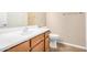 Bathroom with a white sink, toilet, and tile floor, featuring a wood cabinet at 1008 W Heatherwood St, San Tan Valley, AZ 85140