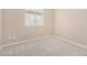 Bright bedroom featuring a window and neutral carpet flooring at 1008 W Heatherwood St, San Tan Valley, AZ 85140