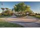 Well-maintained entrance to a Primary-planned community with circular drive, mature trees, and lush landscaping at 1008 W Heatherwood St, San Tan Valley, AZ 85140