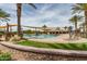Community pool area featuring lounge chairs, palm trees, and covered seating areas at 1008 W Heatherwood St, San Tan Valley, AZ 85140