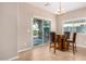 Bright dining area with tile floors, wood table set and sliding glass doors to the backyard at 1008 W Heatherwood St, San Tan Valley, AZ 85140
