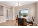 Bright dining area features tile floors, a glass table set, and sliding glass doors to the backyard at 1008 W Heatherwood St, San Tan Valley, AZ 85140