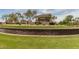 Stone entrance sign for Ironwood Crossing by Fulton Homes set on manicured lawn with trees at 1008 W Heatherwood St, San Tan Valley, AZ 85140