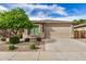Charming single-story home features a well-maintained yard with attractive landscaping and a two-car garage at 1008 W Heatherwood St, San Tan Valley, AZ 85140