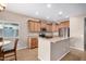Well-lit kitchen boasts granite countertops, stainless steel appliances, and light wood cabinetry at 1008 W Heatherwood St, San Tan Valley, AZ 85140