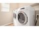 Well-lit laundry room with a modern washer and dryer set at 1008 W Heatherwood St, San Tan Valley, AZ 85140