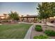 Landscaped community space featuring lush lawn and covered picnic area with tables and grills, for outdoor fun and relaxation at 1008 W Heatherwood St, San Tan Valley, AZ 85140