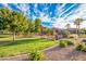 Community playground with green grass and several benches at 1008 W Heatherwood St, San Tan Valley, AZ 85140