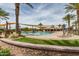 Community pool surrounded by desert landscaping, shade structures, and comfortable lounge chairs at 1008 W Heatherwood St, San Tan Valley, AZ 85140