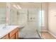 Nicely tiled shower with glass surround, double shower heads, and a seating area at 1008 W Heatherwood St, San Tan Valley, AZ 85140