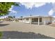 Expansive backyard showcasing desert landscaping and covered patio at 10222 N 105Th Dr, Sun City, AZ 85351