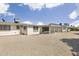The backyard features desert landscaping, a covered patio, and a tranquil setting at 10222 N 105Th Dr, Sun City, AZ 85351