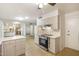 Bright kitchen featuring white cabinets, countertops, and modern stainless steel appliances at 10222 N 105Th Dr, Sun City, AZ 85351